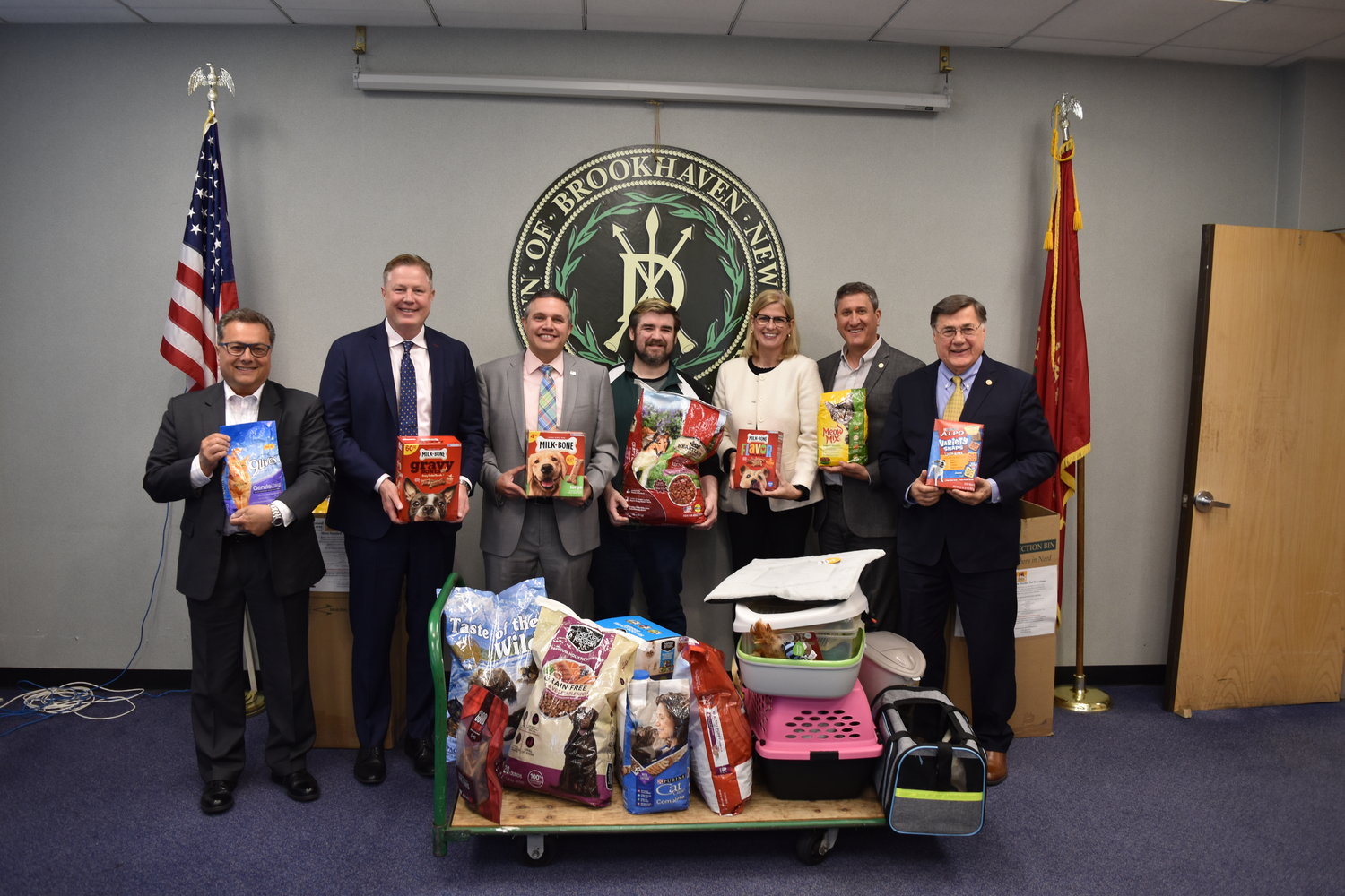 Pictured left to right are councilman Michael Loguercio; councilman Neil Foley; councilman Kevin LaValle; Long Island Cares - The Harry Chapin Food Bank Food Drive manager, Billy Gonyou; councilwoman Jane Bonner; councilmember Jonathan Kornreich; and supervisor Ed Romaine.